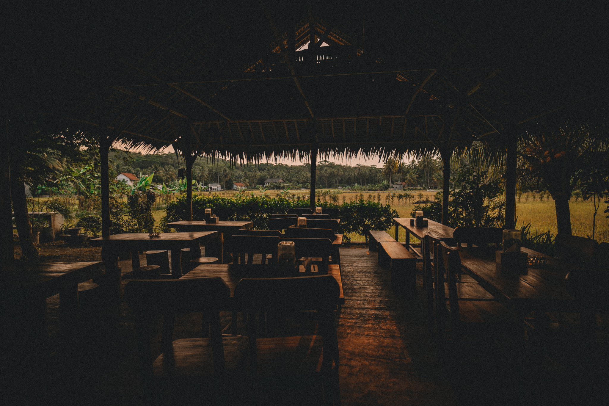 A shaded open-air pavilion looking out onto greenery