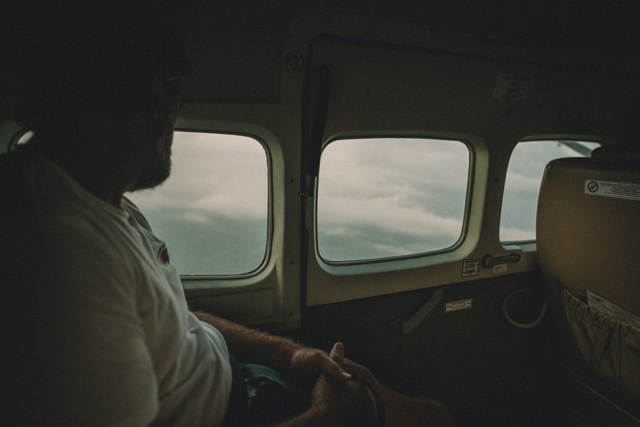 Passengers inside a small aircraft above the clouds