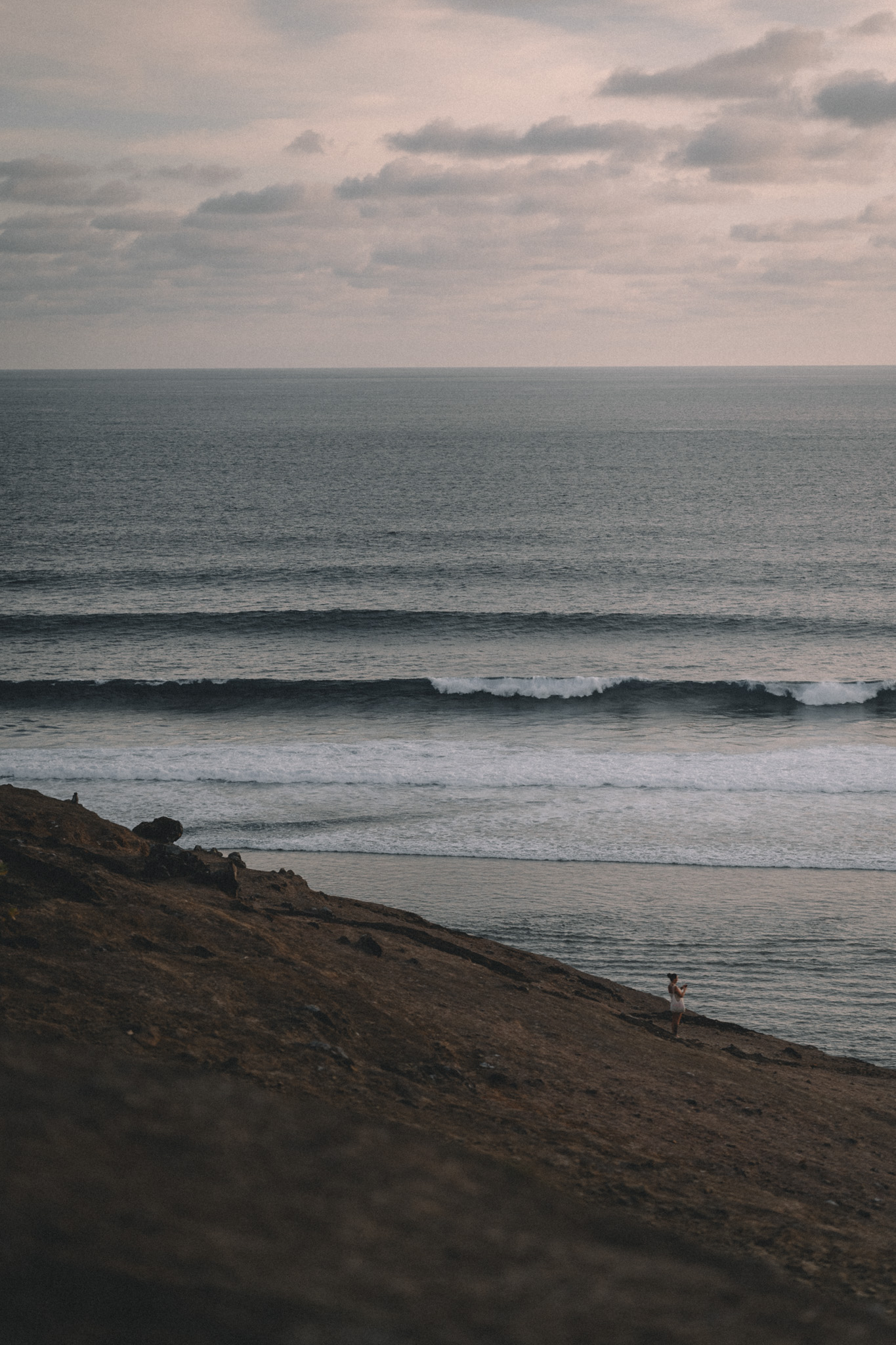 Long lines of surf approaching a quiet coast