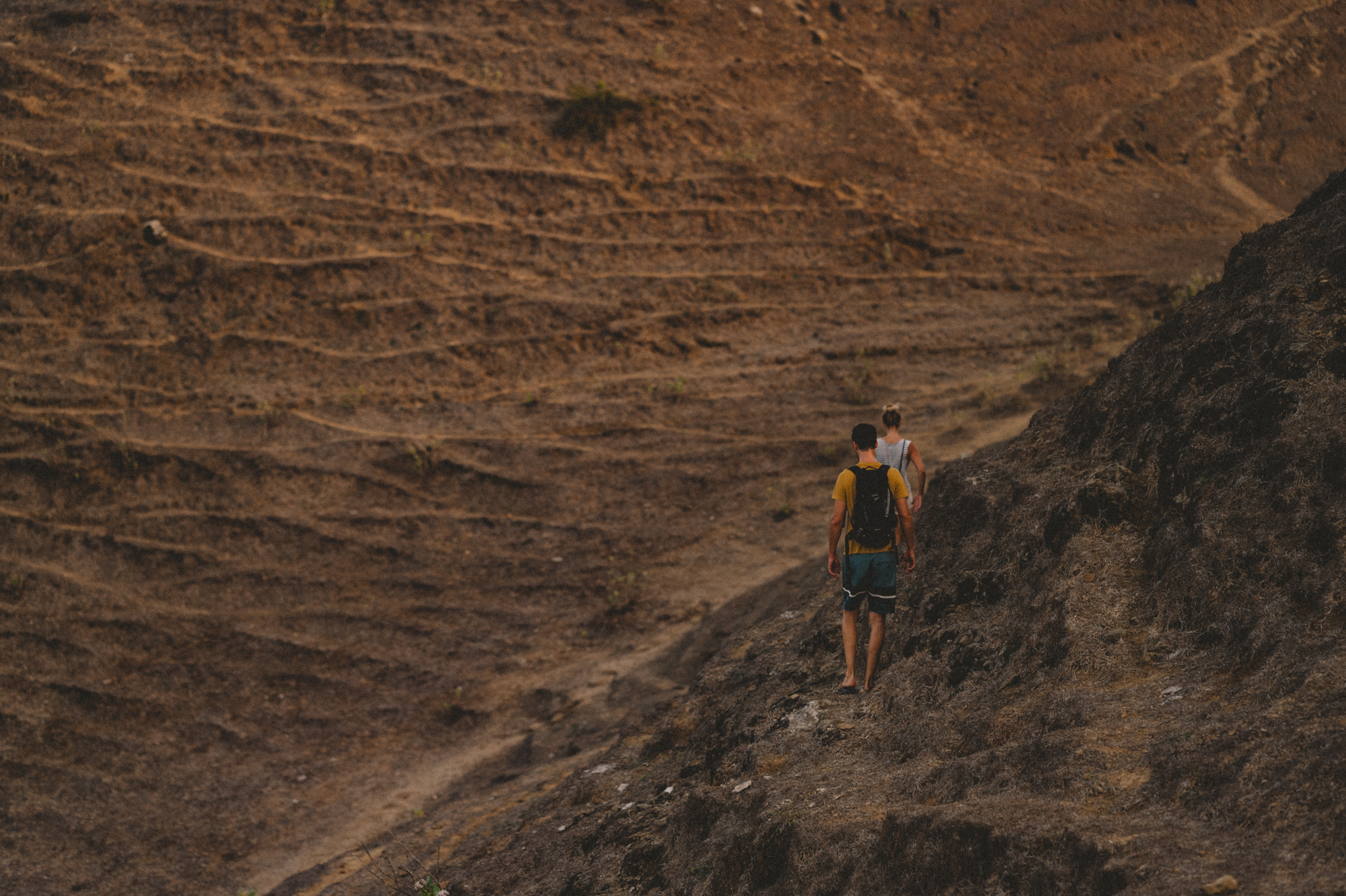 A hiker crossing a rocky slope