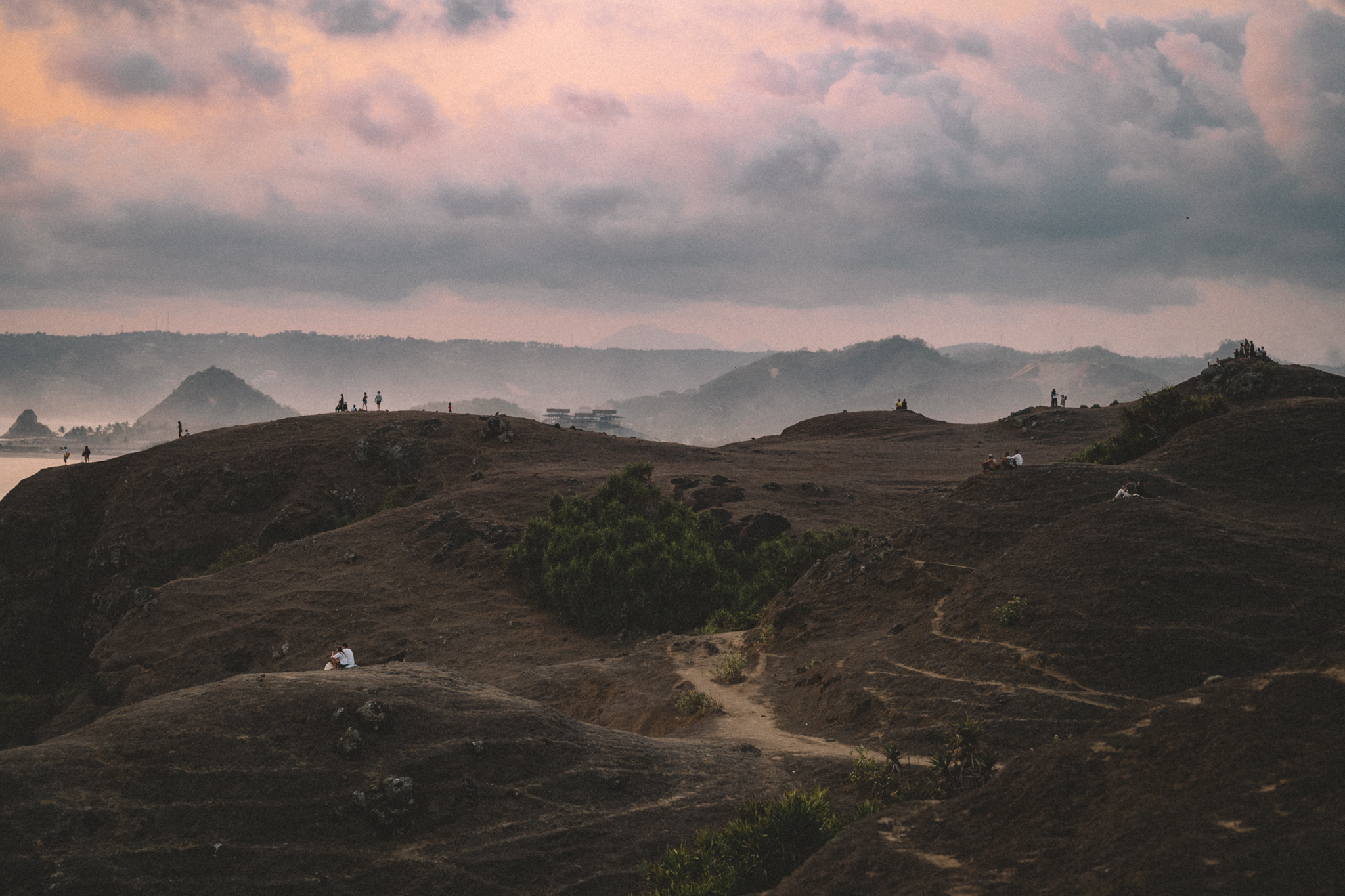 Wide hills beneath a pink evening sky