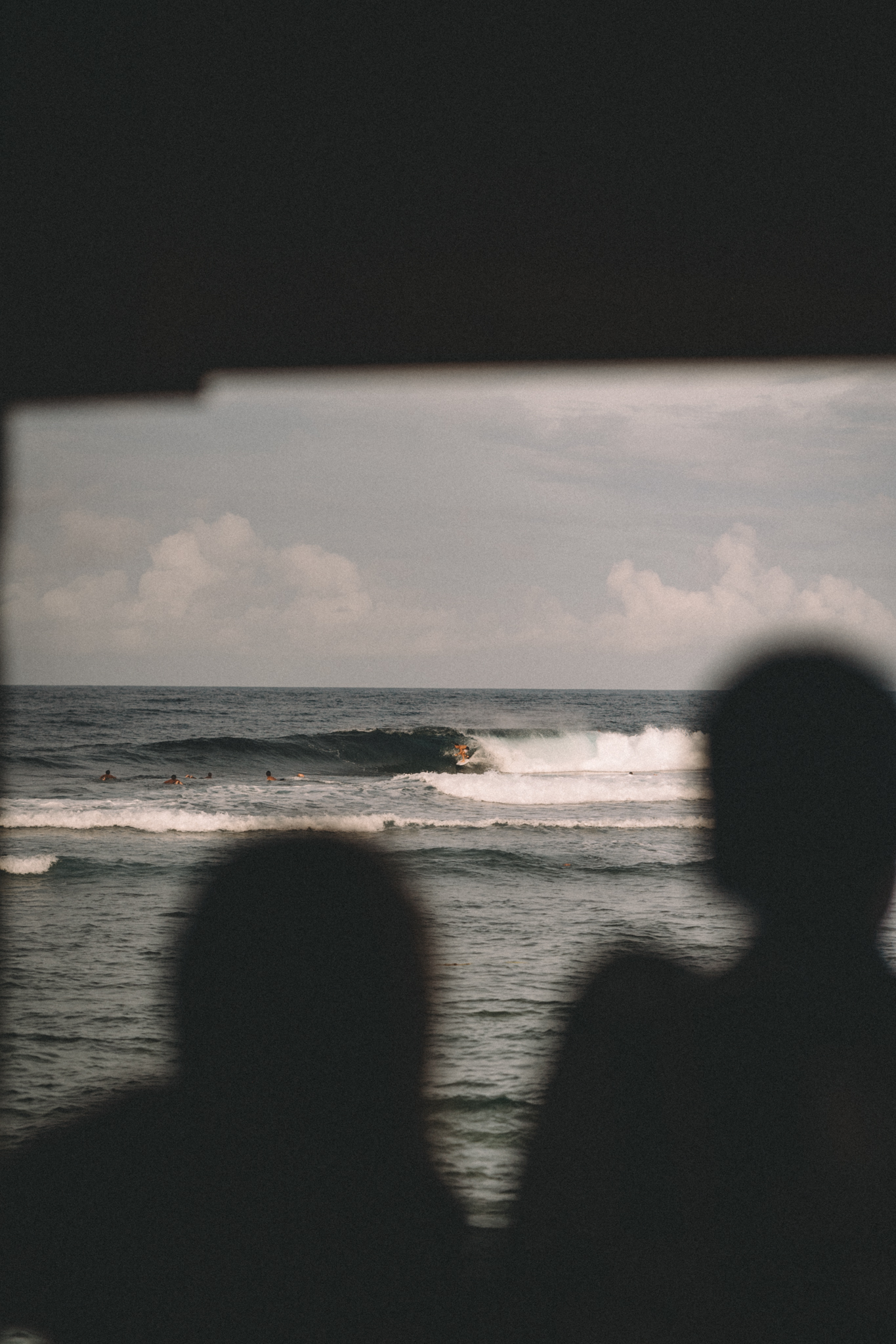 Silhouettes looking out toward the surf