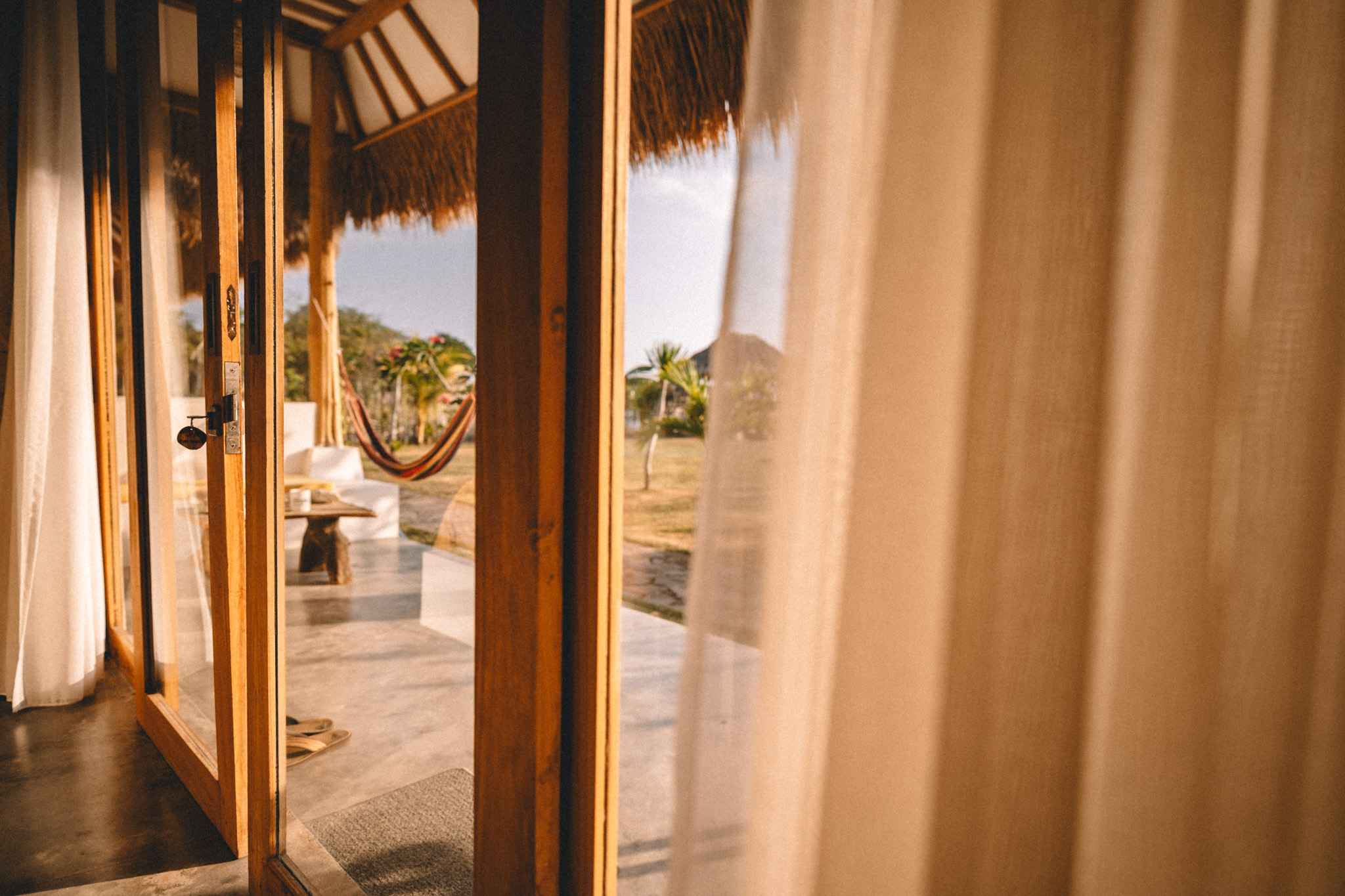 Golden light through curtains and open doors