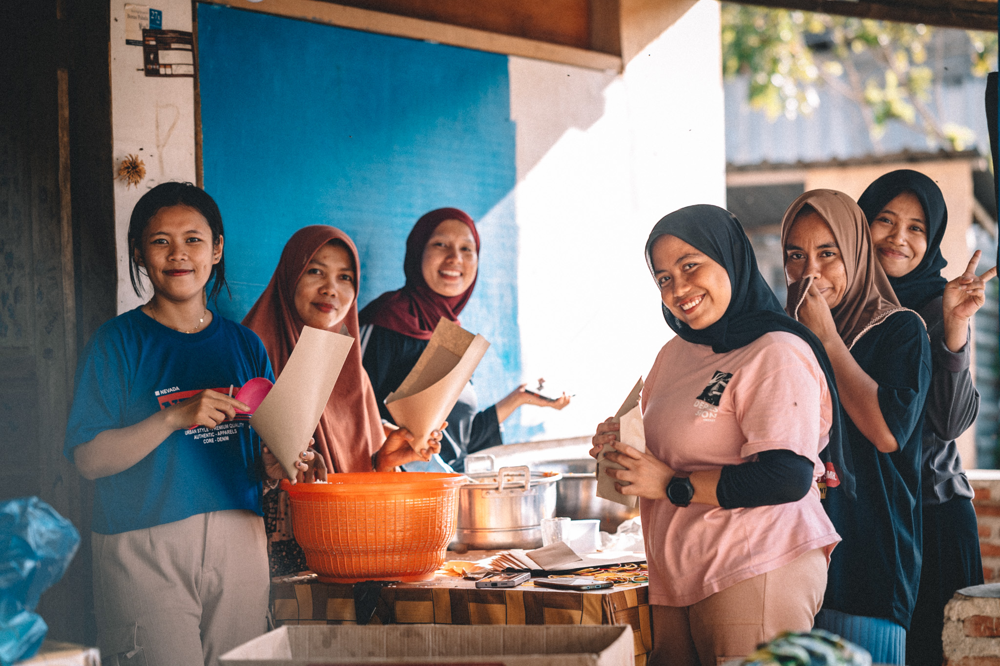 A group gathered around a food counter