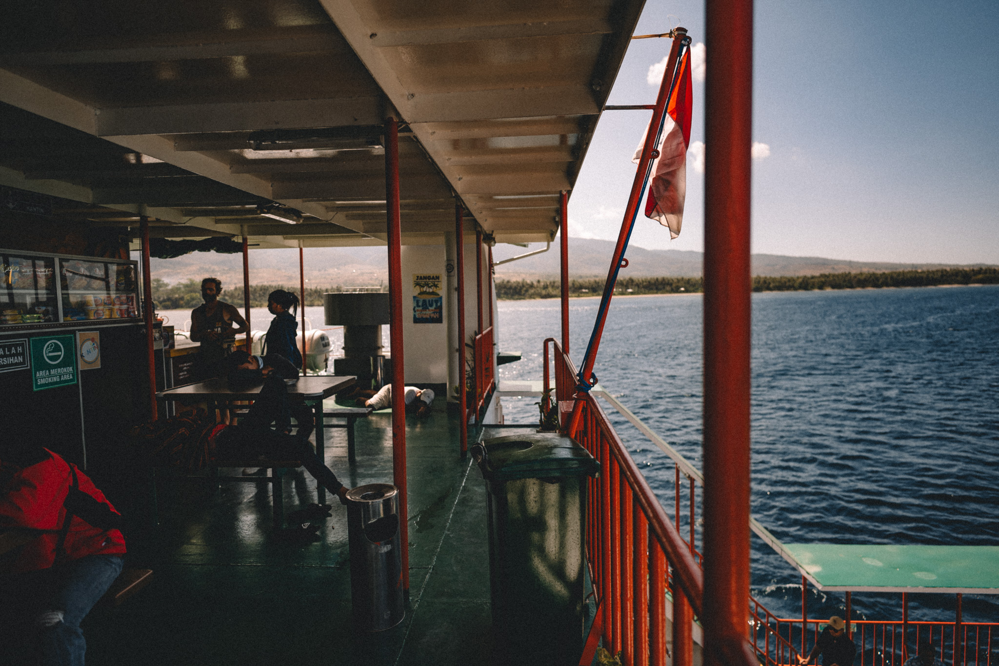 Passengers aboard a ferry with the sea beyond