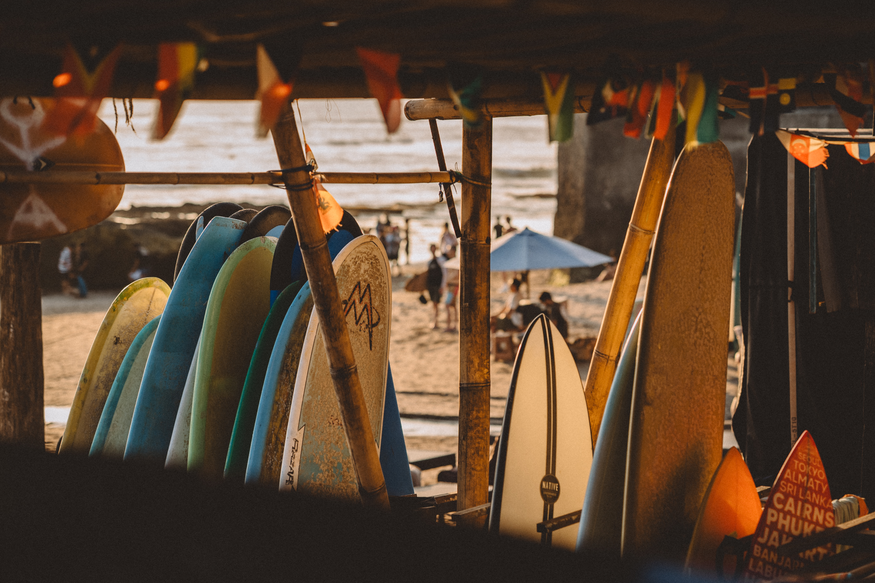 Surfboards in warm light inside a beachside shelter in Bali