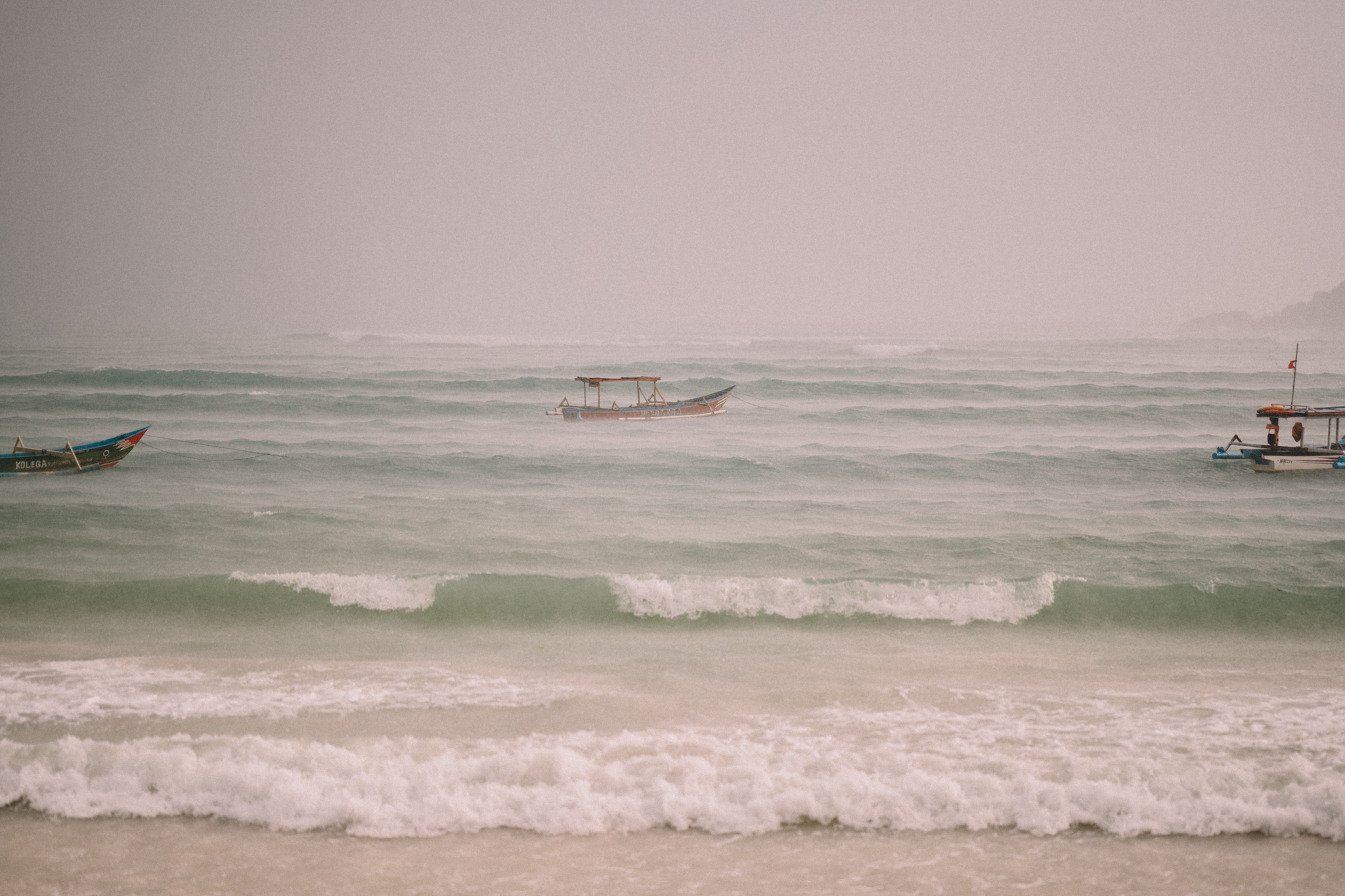Fishing boats in wind and rain off the coast of Lombok